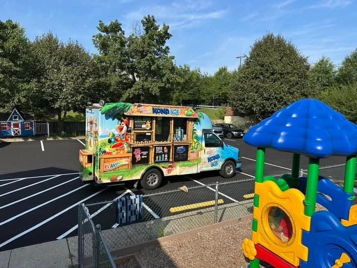 Happy Faces community event with children, parents, and food truck